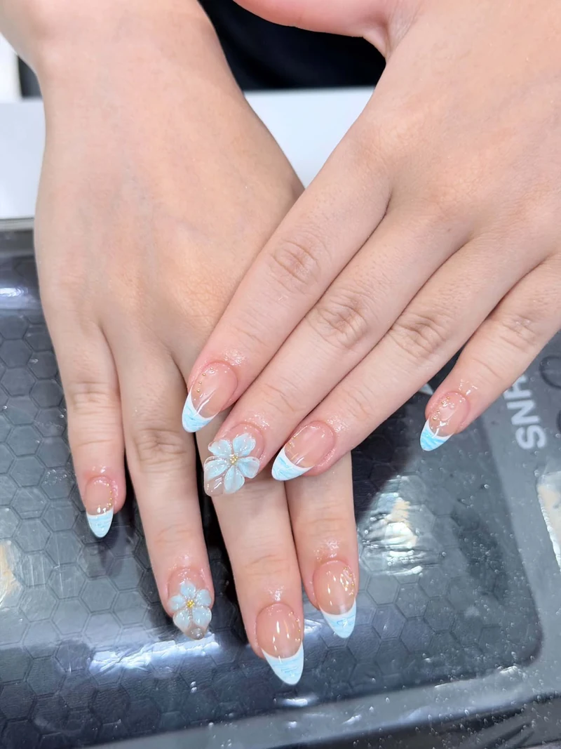 Blue French tips with floral decoration