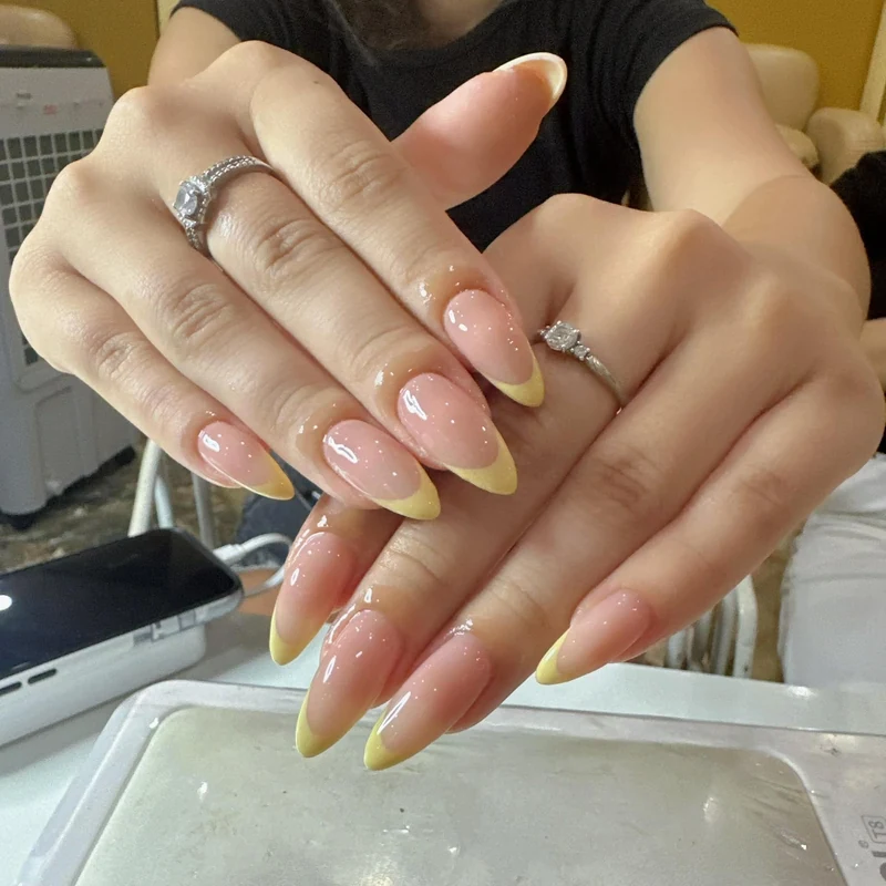 Pink and yellow French almond nails from the supplied LENA collection